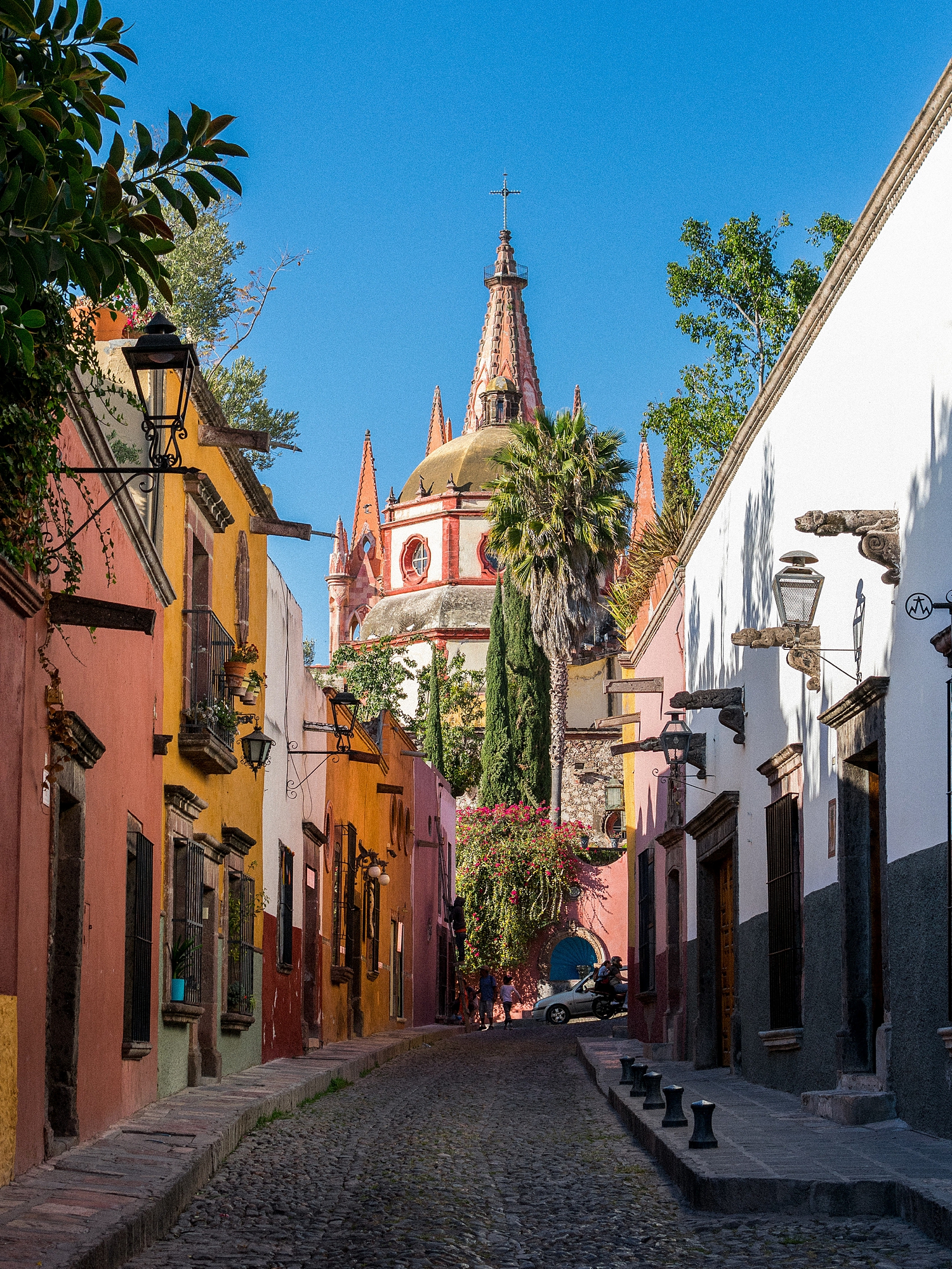 cobblestone street with colorful buildings in and church roofs San Miguel De Allende Mexico Wedding destination
