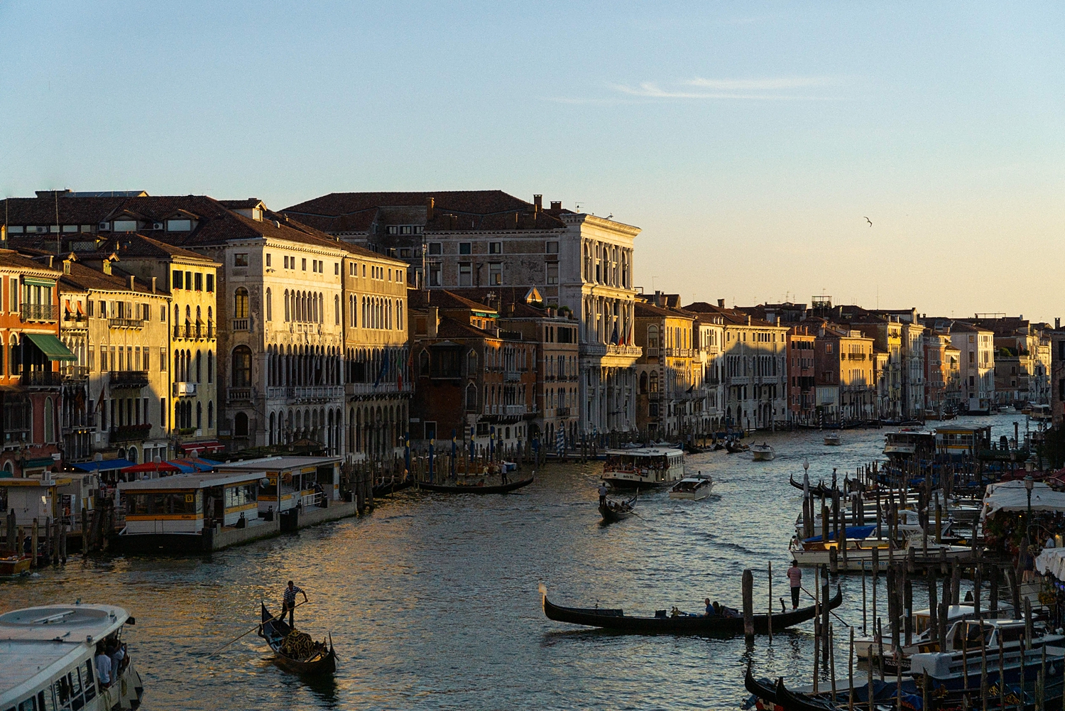 Grand Canal orange and yellow buildings at sunset in Venice, Italy