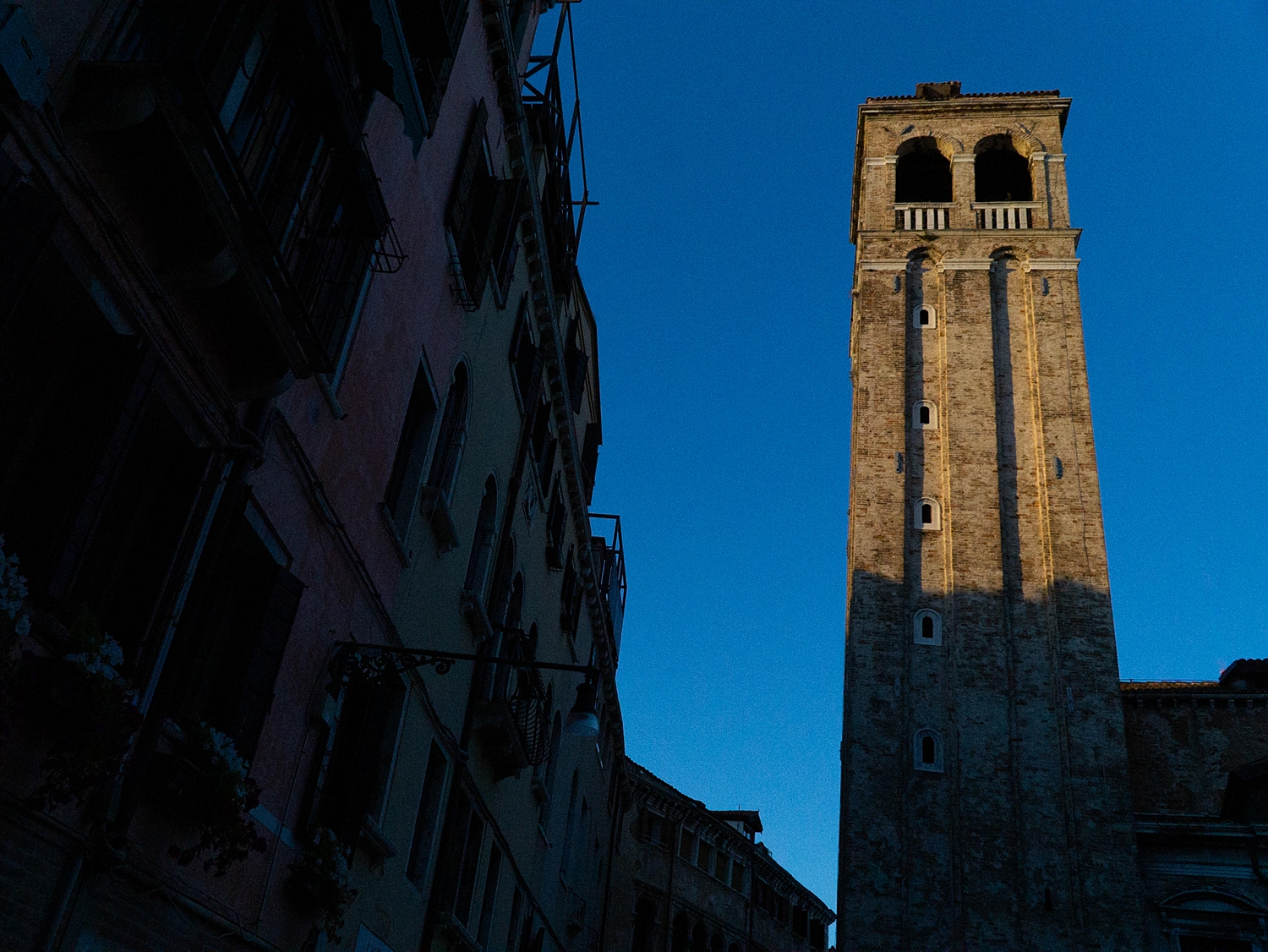 Evening in Venice church tower leaning against blue sky