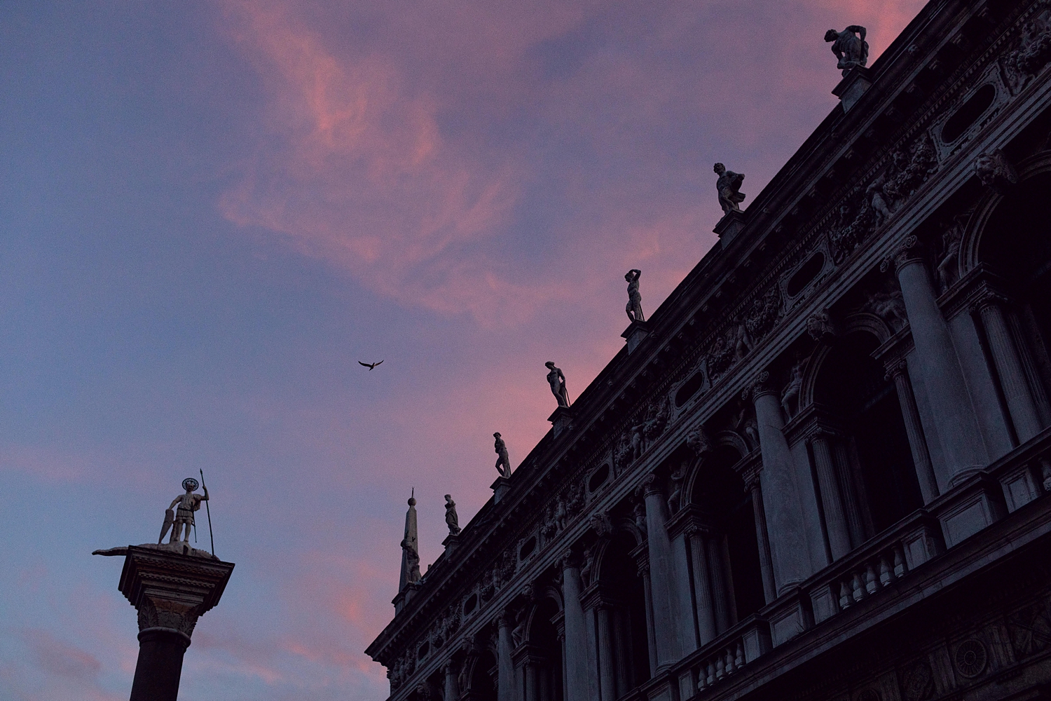 Top of Doge's Palace in Palazzo Ducale Venice, Italy at sunset with purple sky