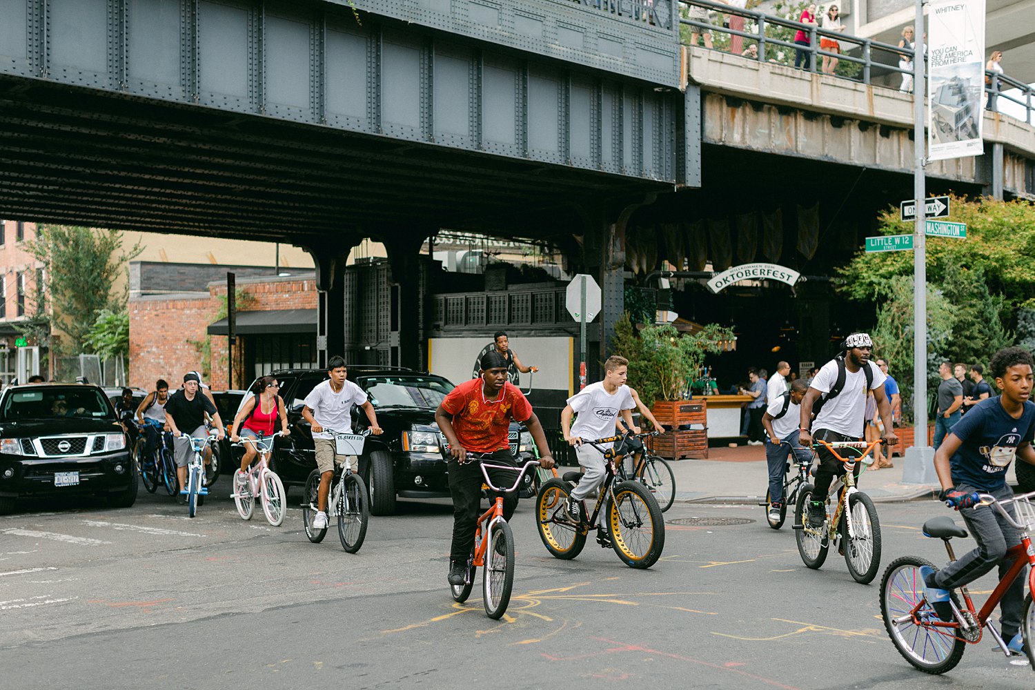 Group of bike riders traveling under the Highline in Chelsea NYC places to visit in New York