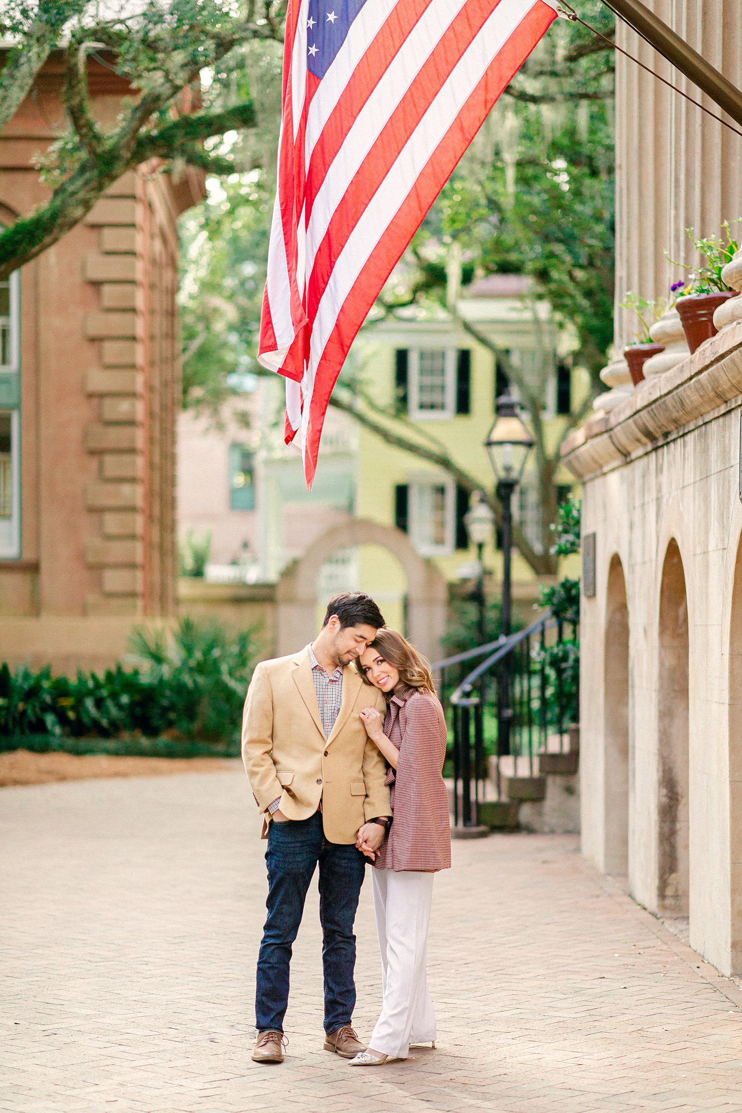 Couple Standing together under American flag at College of Charleston