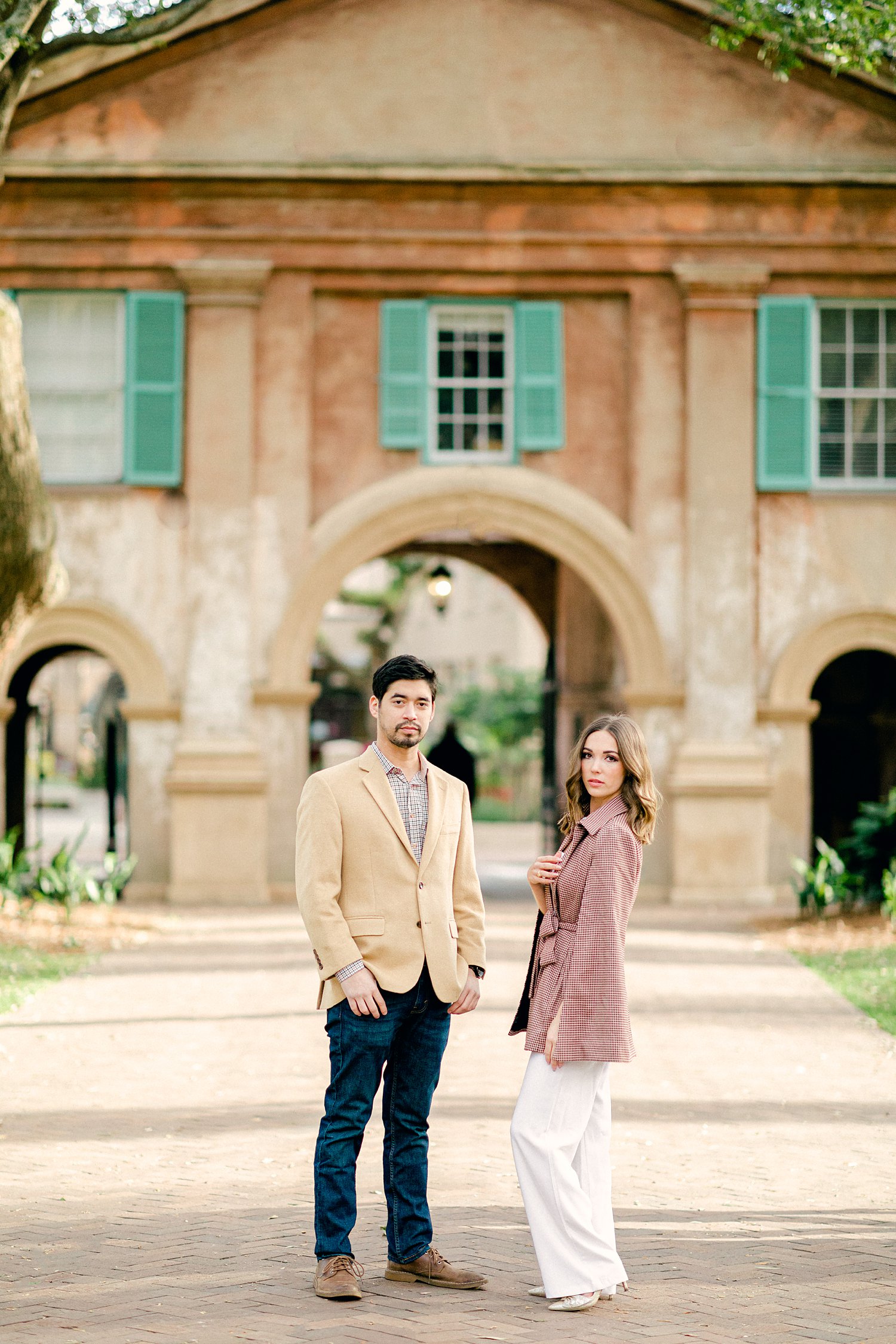 Couple Standing in front of gateway into the College of Charleston