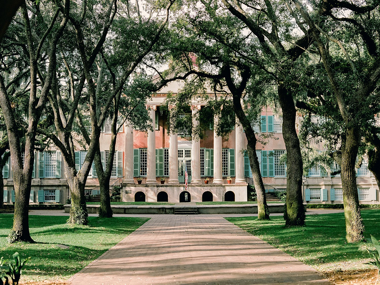 College of Charleston columned building surrounded by green trees
