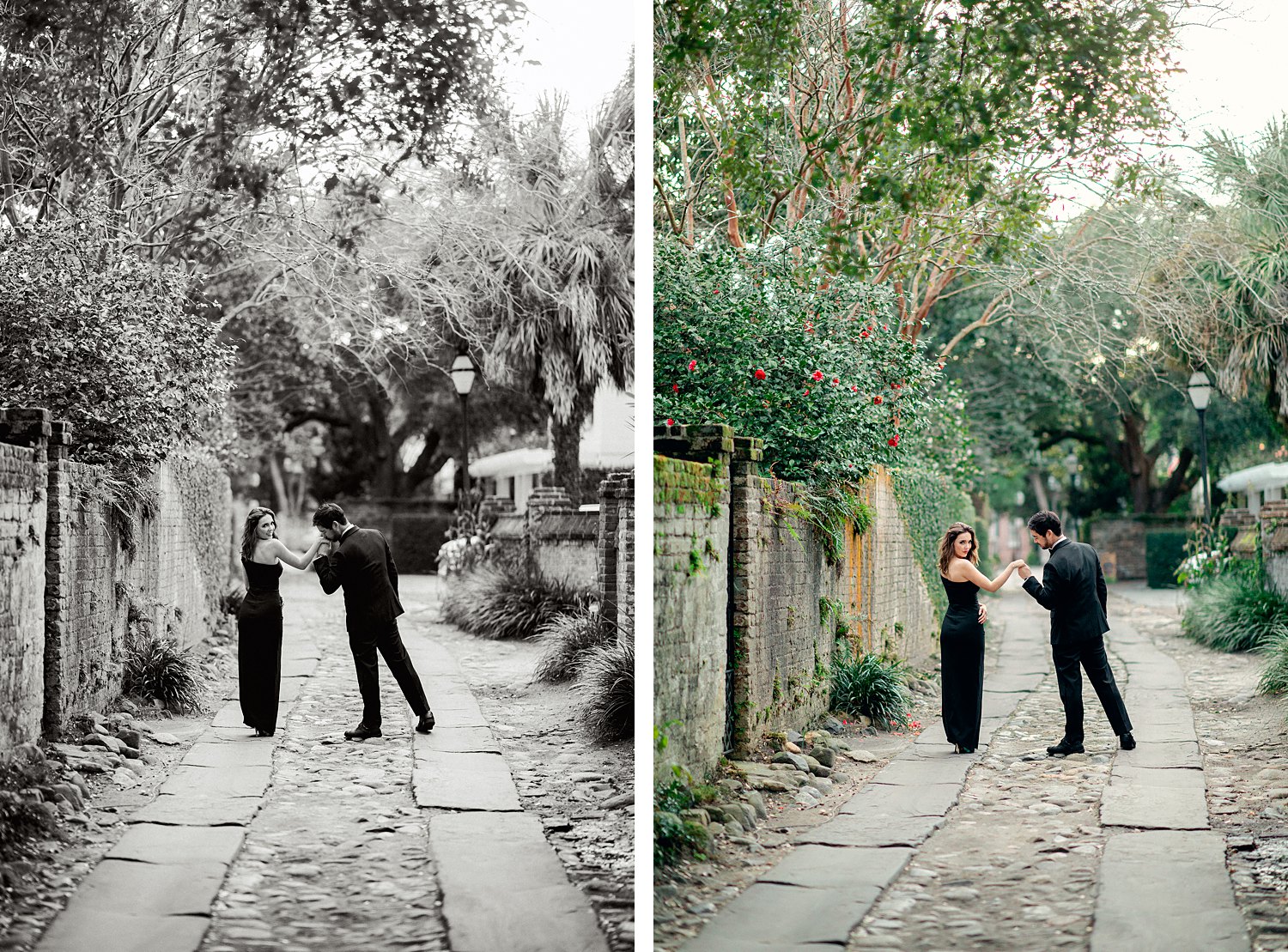 Man in tuxedo kissing hand of woman in black dress while walking down green cobblestone alleyway in Charleston engagement