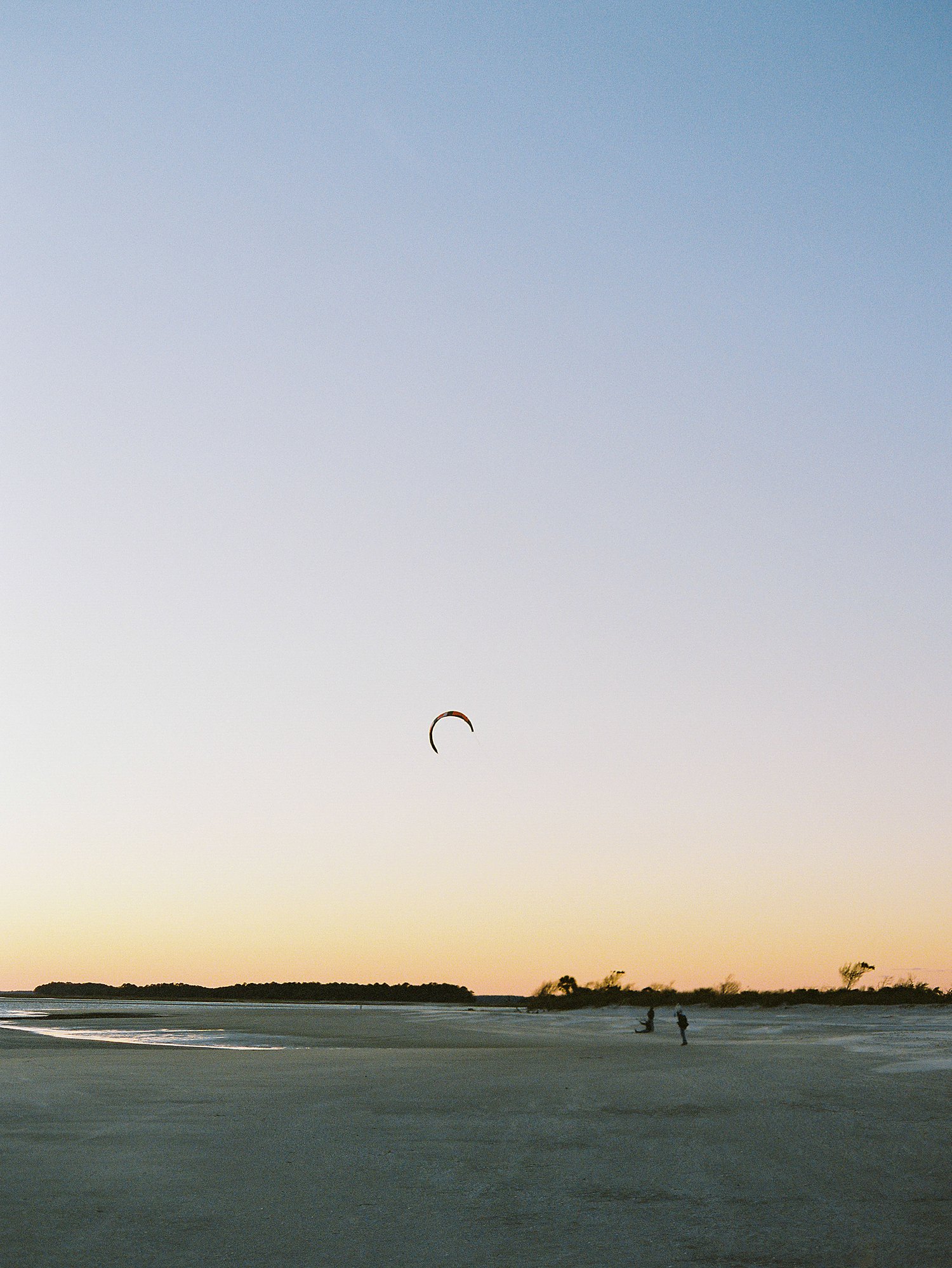 Folly Beach kite flying against blue evening sky