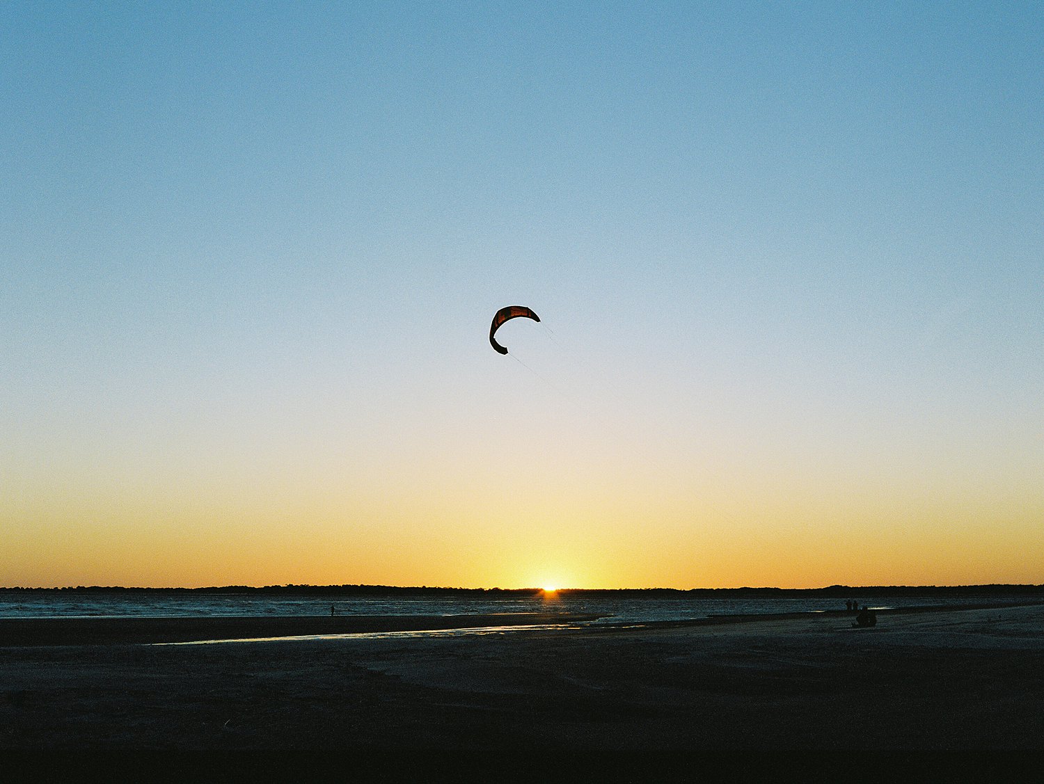 kite flying against blue evening sunset sky