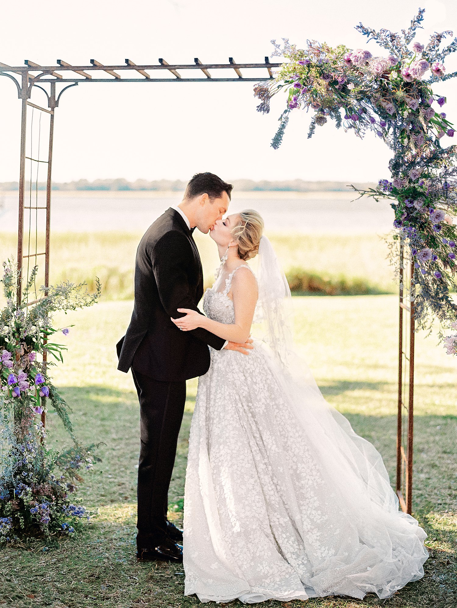 bride and groom kissing at altar of outdoor ceremony at Lowndes Grove Charleston wedding