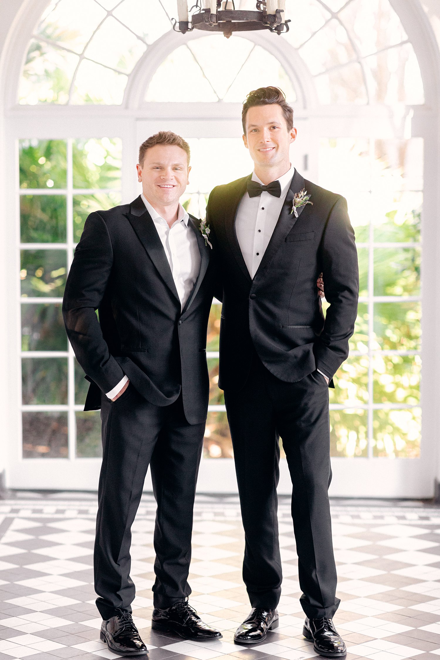 groom and best man in black tuxedos at Lowdnes Grove