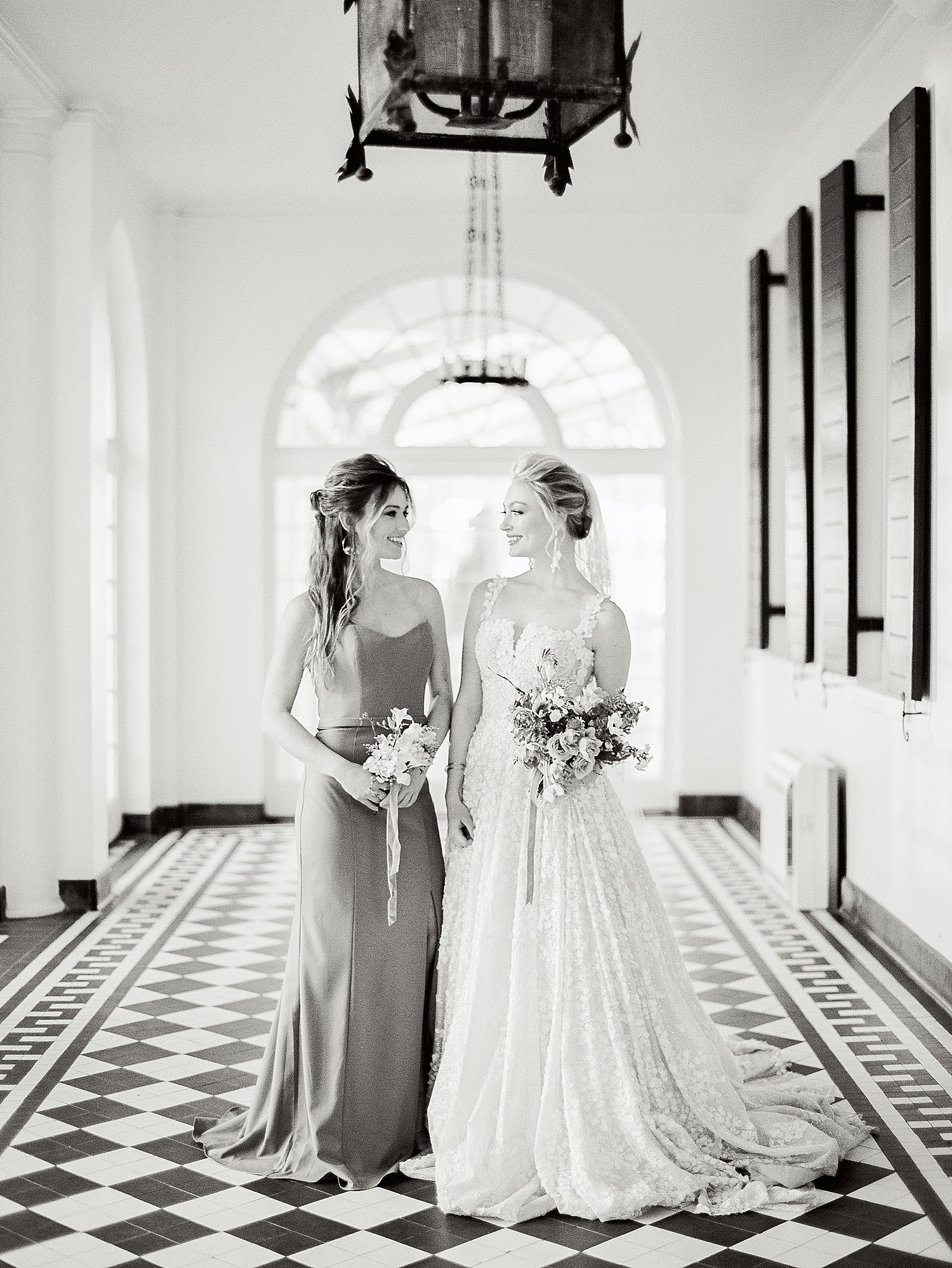 Lowndes Grove Black and white bridesmaid and bride holding flowers