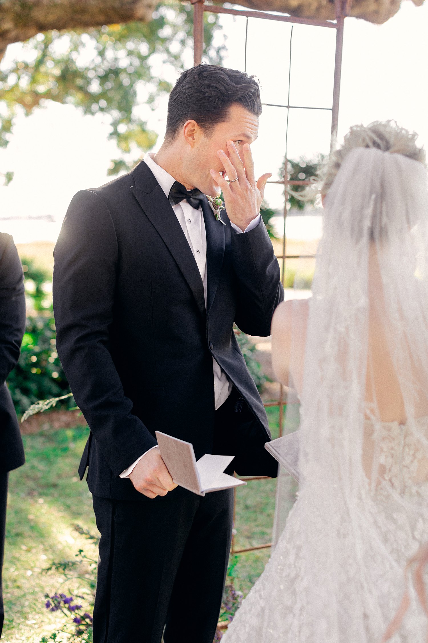 groom crying at altar of outdoor ceremony at Lowndes Grove