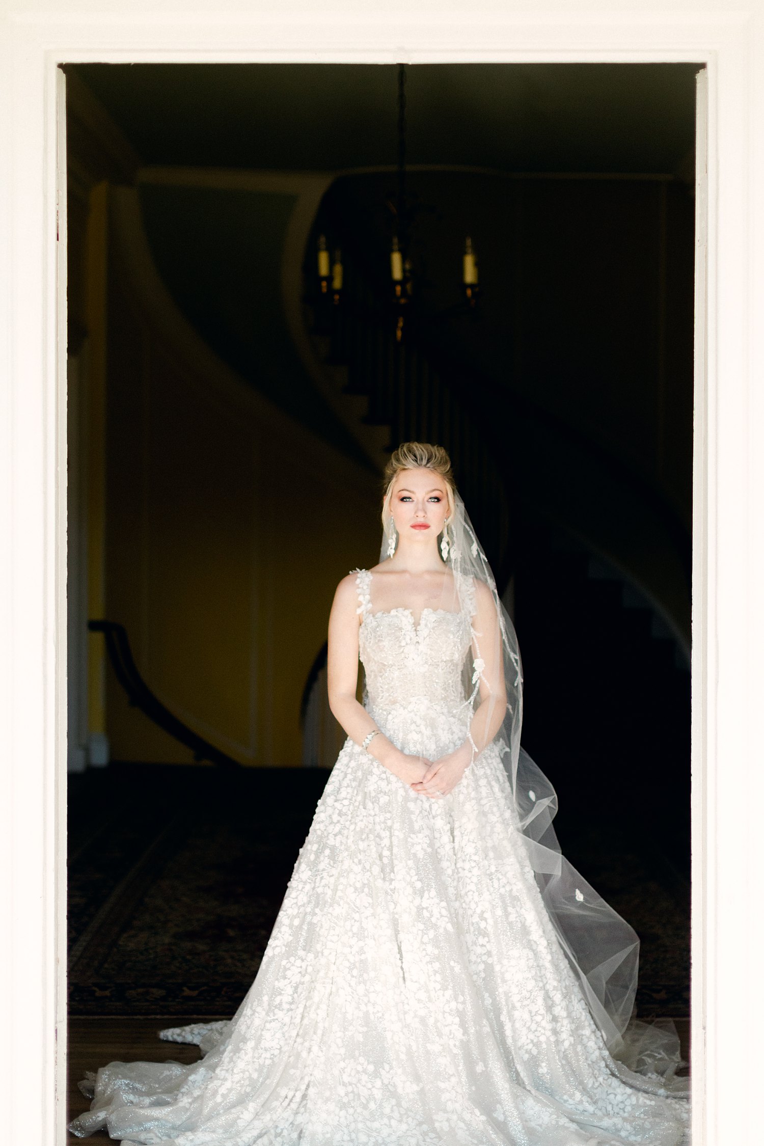 bride in white dress, veiling doorway at Lowndes Grove Charleston wedding