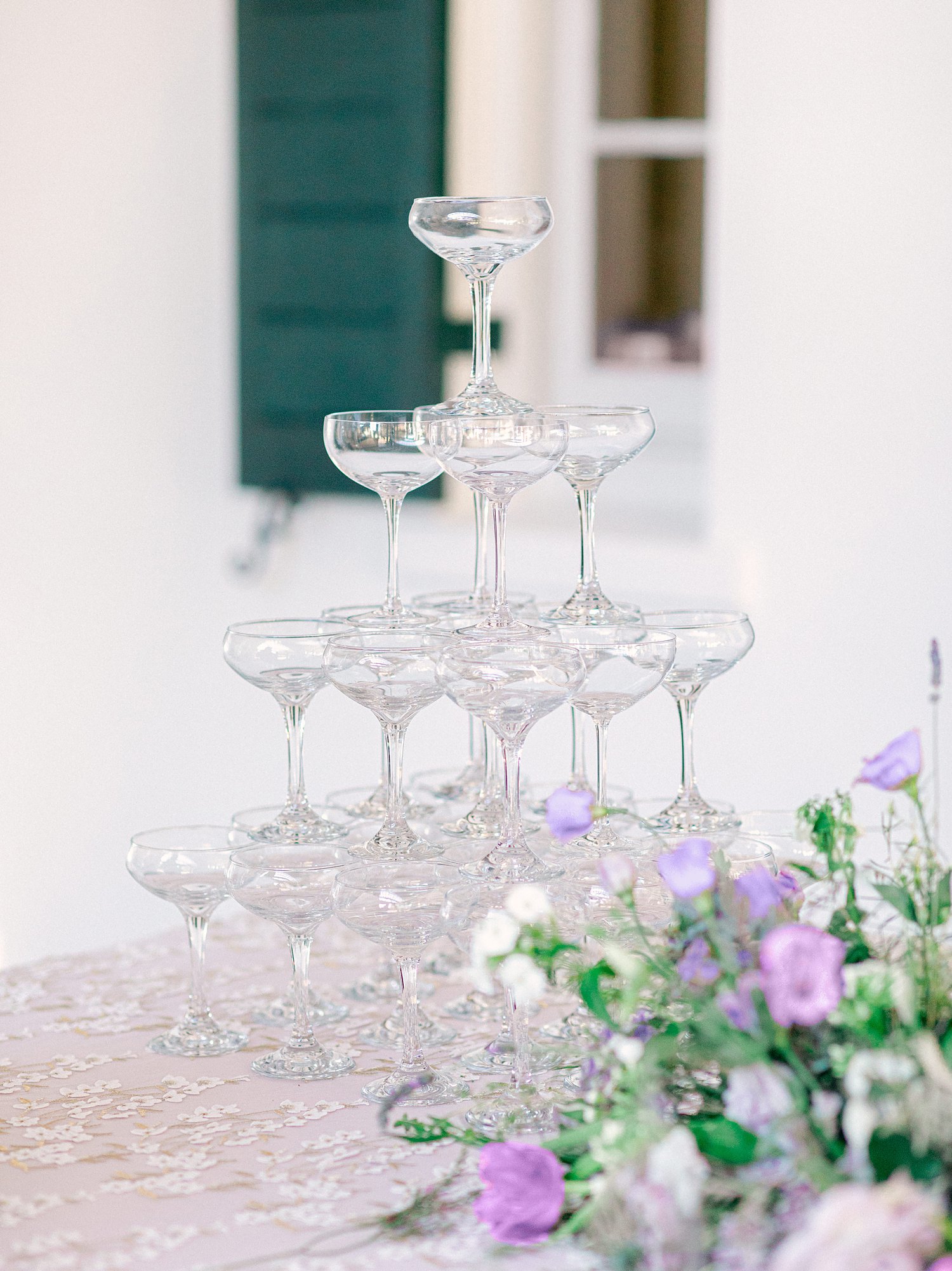 Champaign tower on table with purple linen and florals at wedding reception