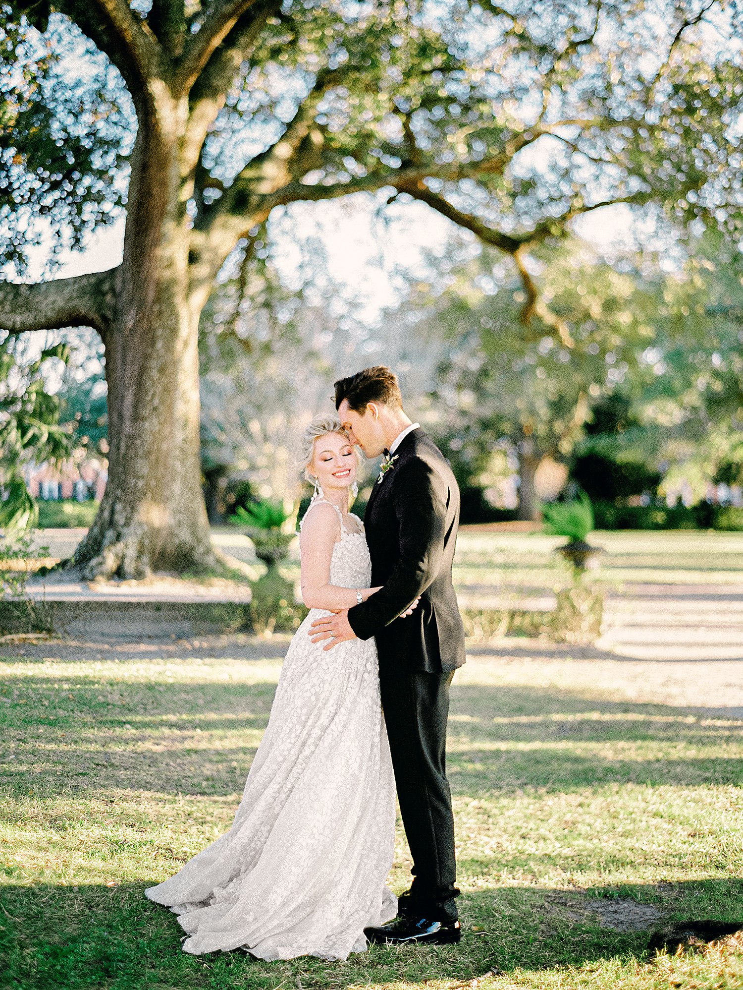 Bride and groom embracing outdoors at Lowndes Grove Charleston wedding