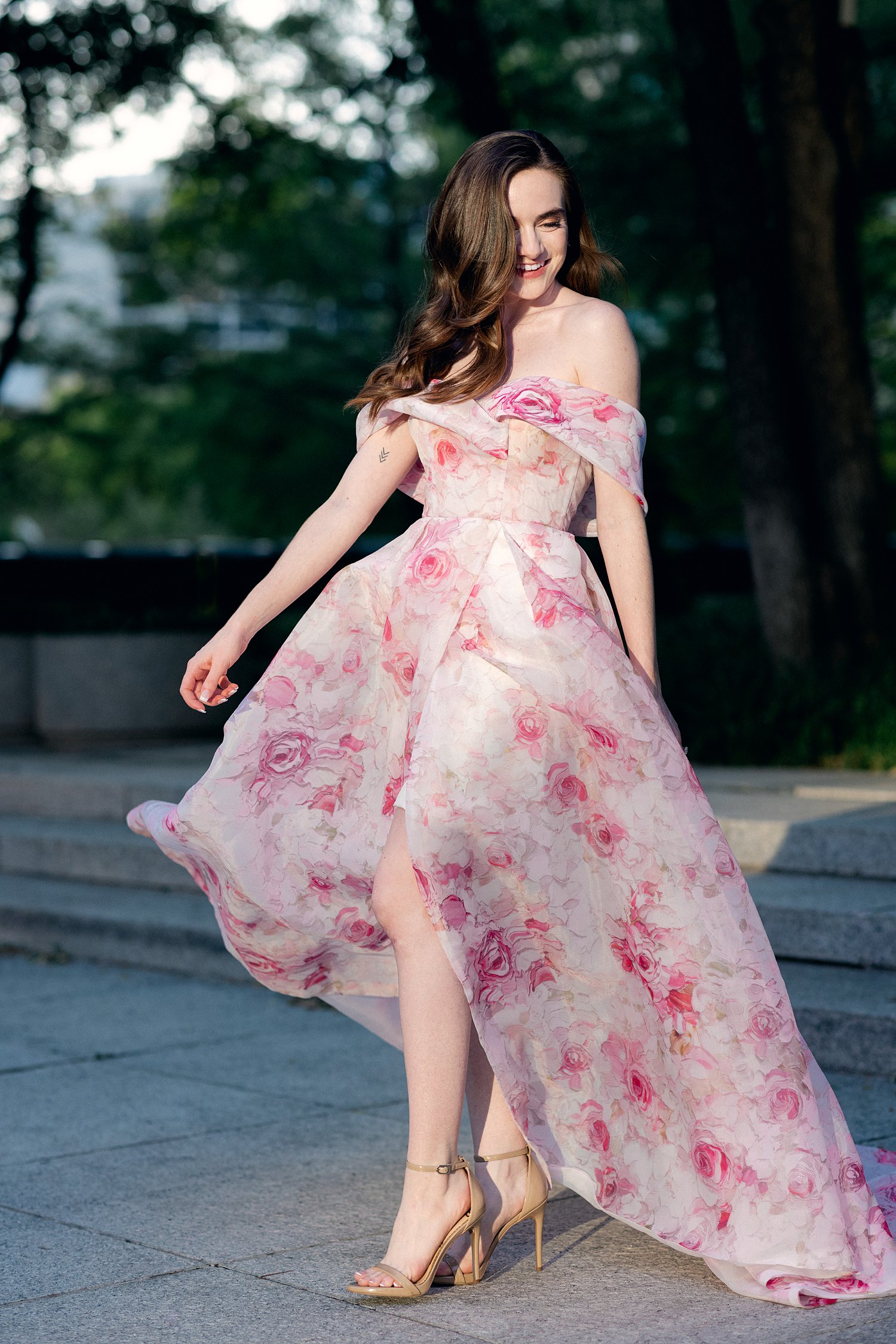 smiling woman in Pink floral gown dancing