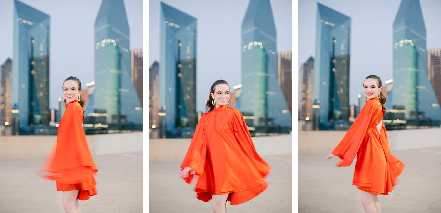 woman in orange dress and pony tail twirling on downtown Dallas rooftop