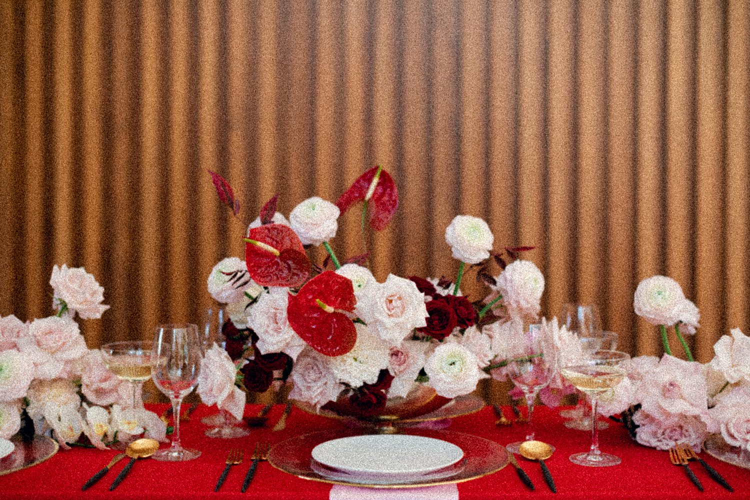 pink and red table florals with white plate and gold silverware Virgin Hotel Dallas
