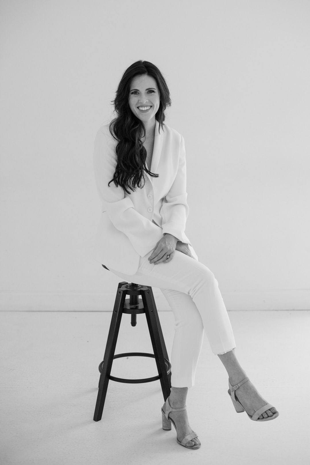 Karli Ivory and Vine Wedding and Event Co. woman sitting on stool black and white