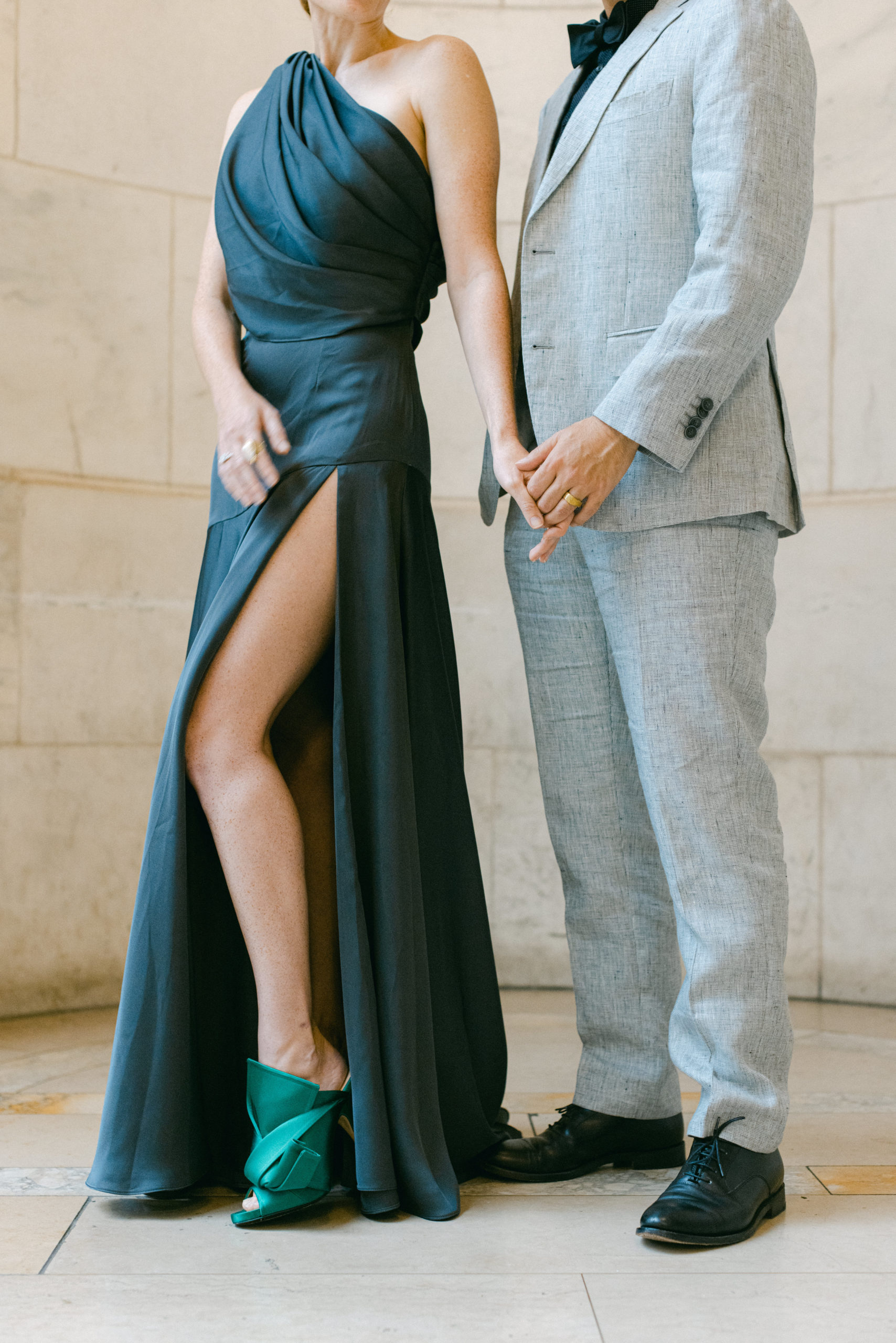 Stylish New York City Couple in grey suit and blue dress with green shoes