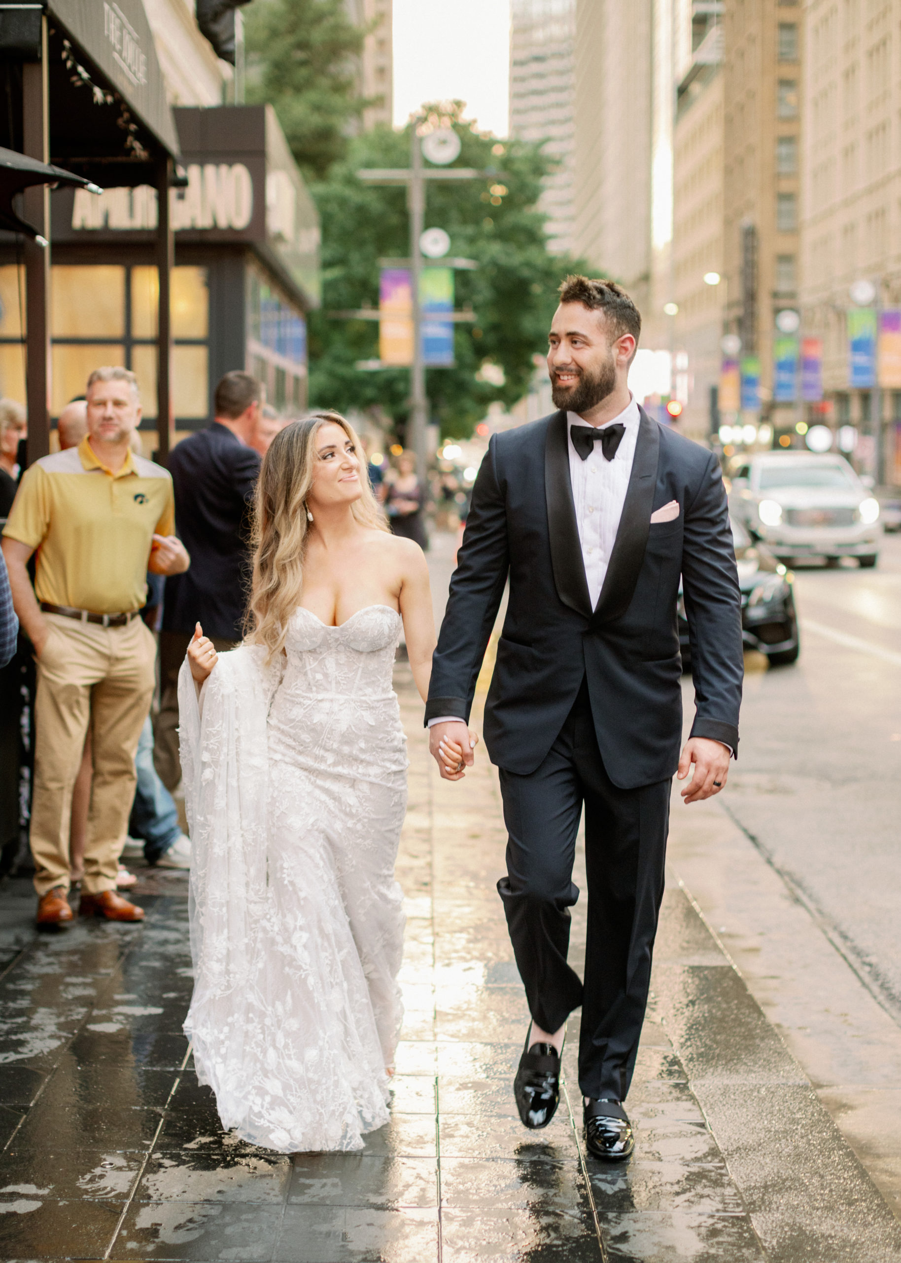 bride and groom walking down sidewalk in Dallas
