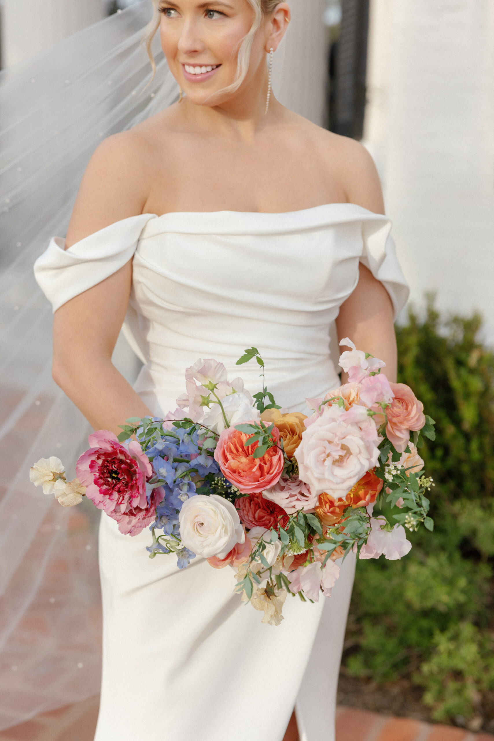 Bride holding colorful bouquet at Woodbine Mansion Wedding