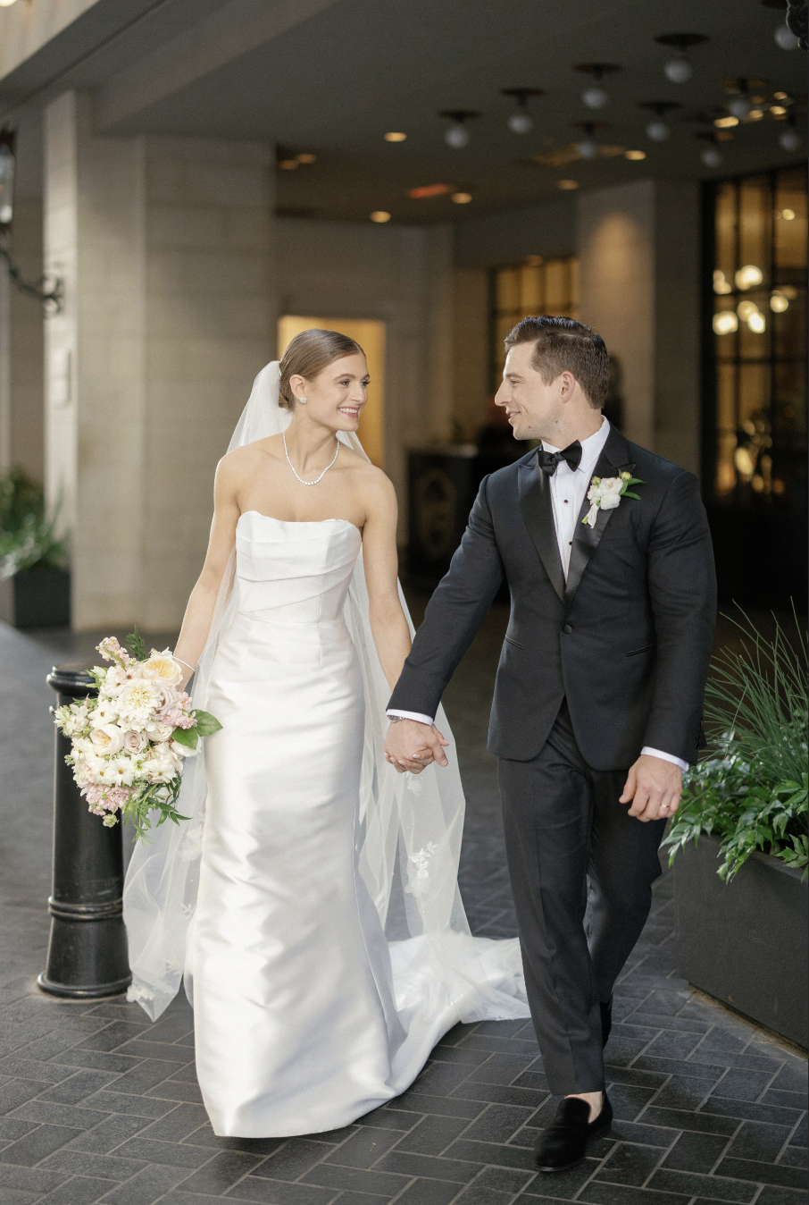 bride and groom walking out of Adolphus wedding